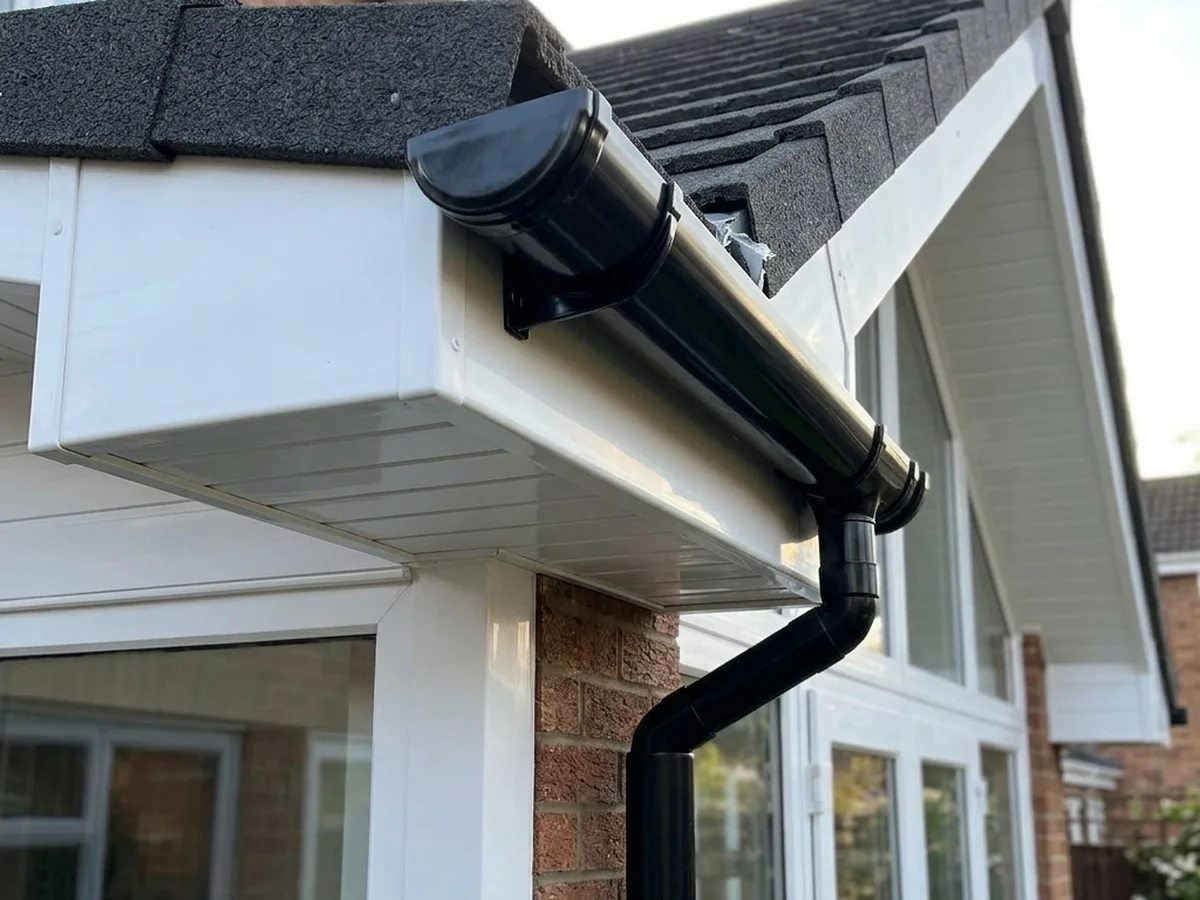 White fascias and soffits with new black guttering and downpipe